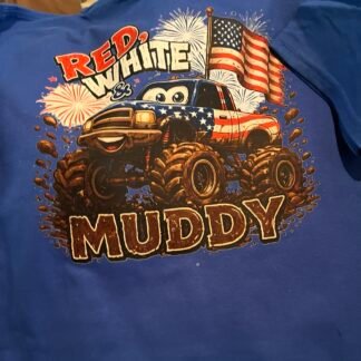 Youth royal blue patriotic monster truck T-shirt featuring a red, white and blue muddy truck, American flag, fireworks, and “Red, White & Muddy” design.